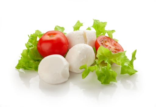 Small balls of Mozzarella with tomato cherry and fresh green lettuce