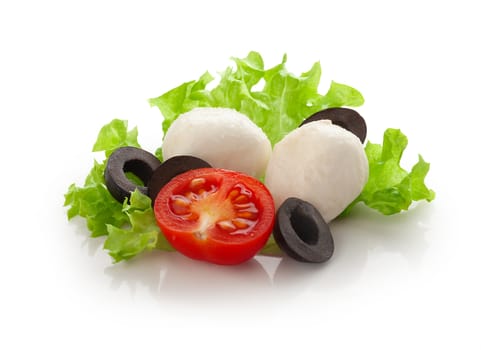 Some balls of mozzarella with half of tomato cherry, black olives and green lettuce