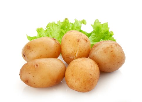 Isolated heap of jacket potatoes with fresh green lettuce