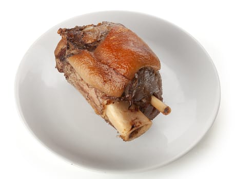Roasted pork knuckle on the white plate