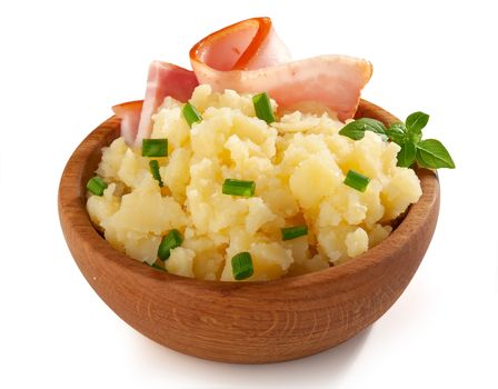 Mashed potatoes with bacon, fresh basil and green onion in the wooden bowl