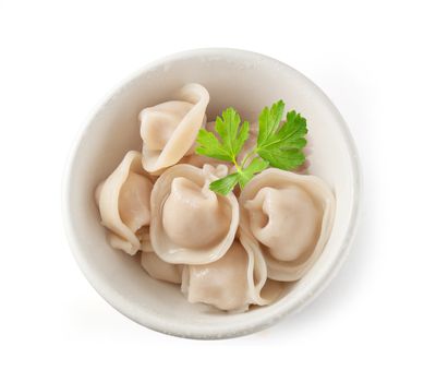 Boiled dumplings with fresh green parsley in the bowl