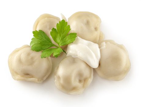 Handful of boiled dumplings with sourcream and fresh parsley leaf