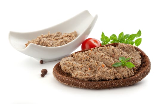 Sandwich with meat pate, tomato, basil and black pepper
