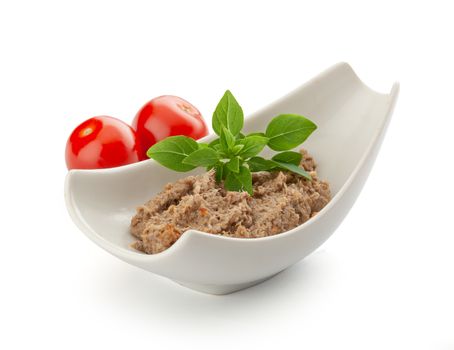 Meat pate in the bowl with fresh tomato and basil