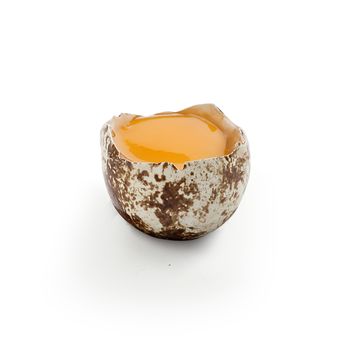 Isolated broken quail egg on the white background