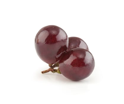 Isolated three berries of red grape on the white background