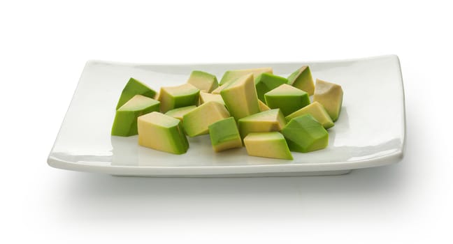 Isolated white plate with avocado cubes on the white