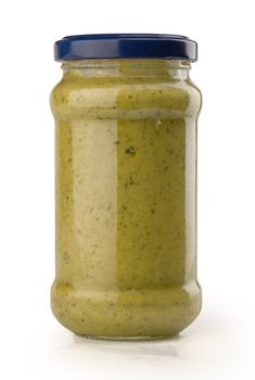 Pesto sauce in the glass jar on the white background