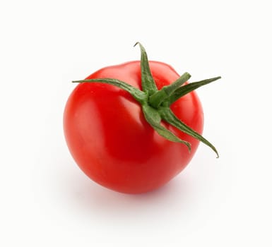 Isolated red fresh tomato with the tail on the white background