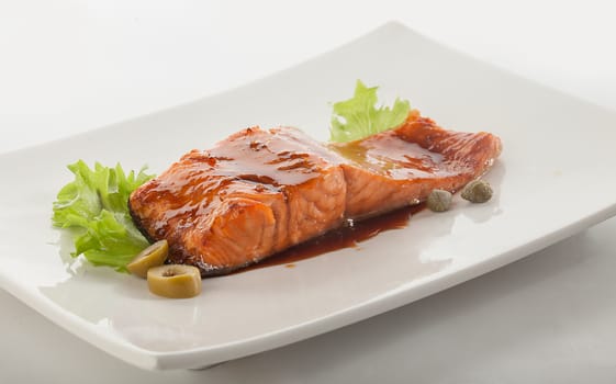 Baked fillet of salmon dressing by narsharab on the white plate
