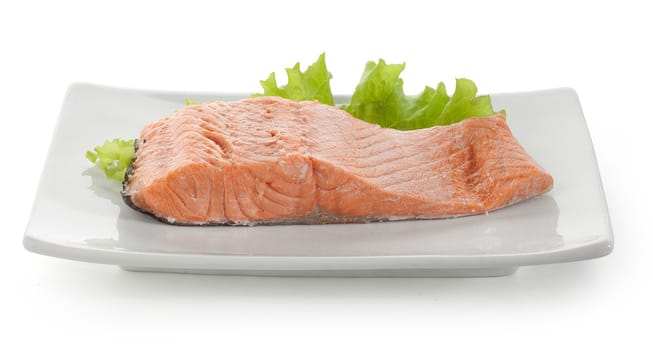 Fillet of trout with fresh lettuce on the plate