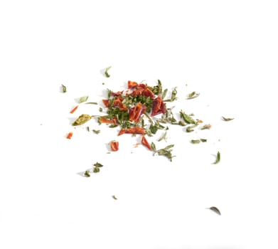 Dried red and green herbs on the white background