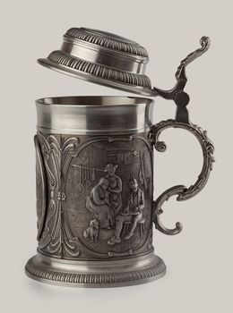 Decorated metal beer mug on the white
