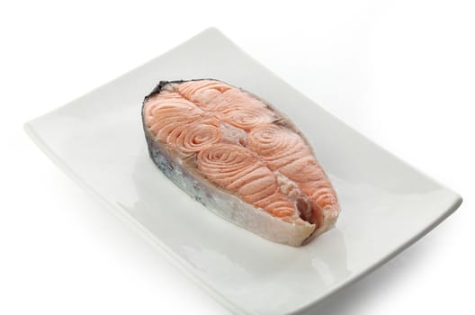 Steamed steak of salmon on the white plate