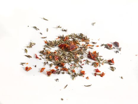 Dried red and green herbs on the white background