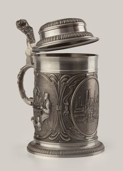 Decorated metal beer mug on the white background
