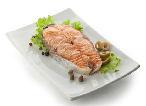 Baked steak of salmon with olives, capers, lettuce and black peppers