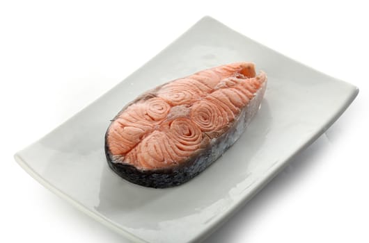 Steamed steak of salmon on the white plate