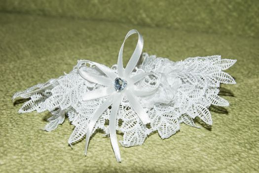 bride garter on green background