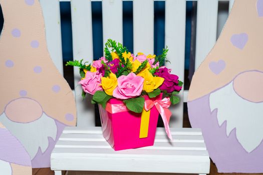 artificial multicolored flowers in a basket