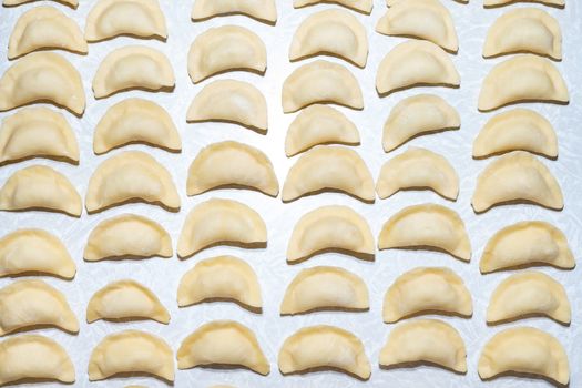 homemade delicious handmade dumplings are dusted with flour and await cooking