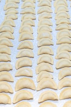 homemade delicious handmade dumplings are dusted with flour and await cooking