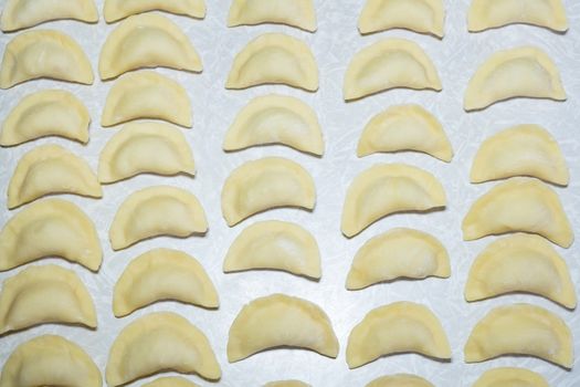 homemade delicious handmade dumplings are dusted with flour and await cooking