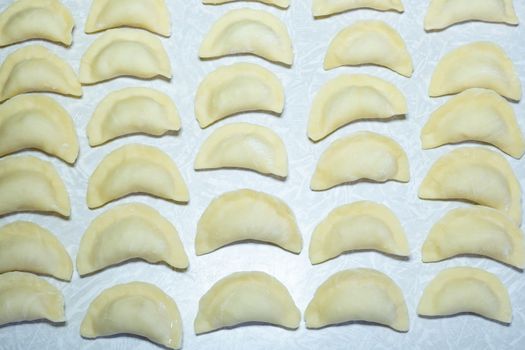 homemade delicious handmade dumplings are dusted with flour and await cooking