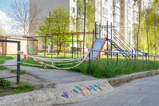 the playground is closed by a quarantine tape during coronavirus