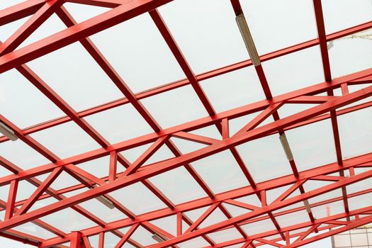 red metal construction holds a transparent roof