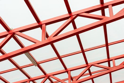 red metal construction holds a transparent roof