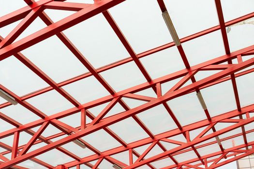 red metal construction holds a transparent roof