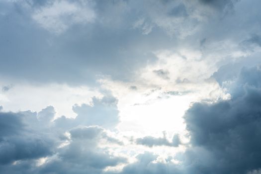 the bright sun looks through the storm clouds