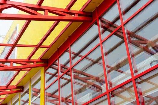 red metal construction holds a transparent roof