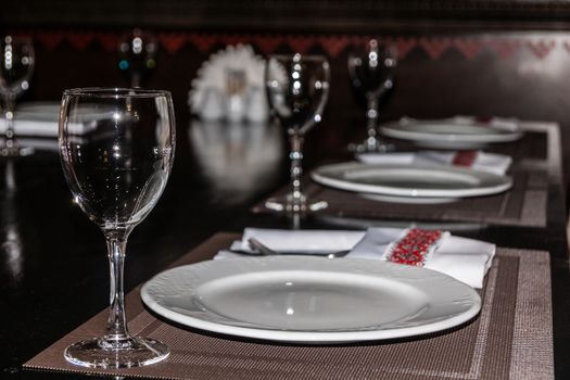 restaurant table setting, wine glasses and plates