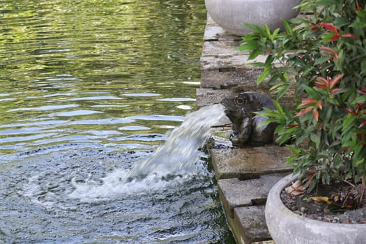 Frog spewing out water fountain. Fountain in the form of a frog statue, Bali, Ubud.