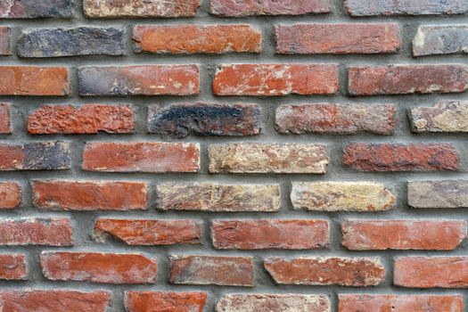 Ancient wall made of darkened red brick