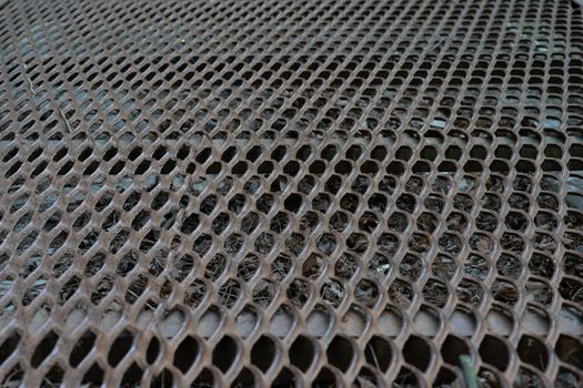 the metal rusty lattice is photographed at an angle