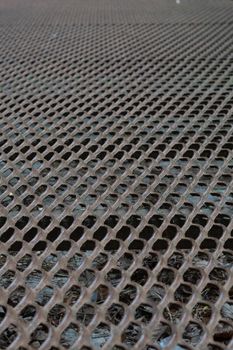 the metal rusty lattice is photographed at an angle