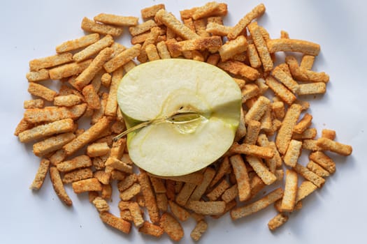 Half an apple lies on a pile of delicious breadcrumbs              