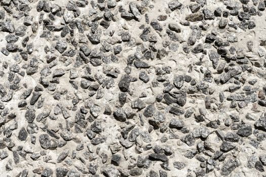 Background: Concrete product made of large granite rubble