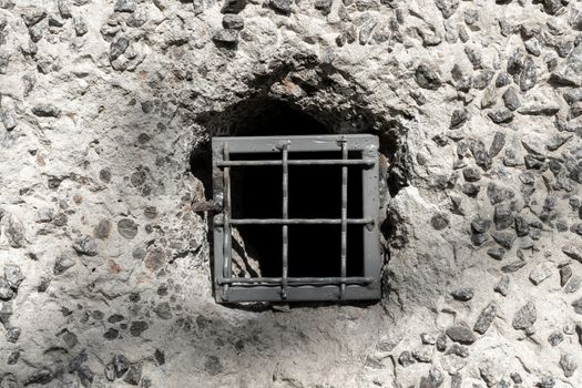 Concrete wall with a metal lattice in a small hole