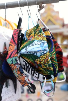 Mask with a variety of patterns Hanging on the waiting rack for sale