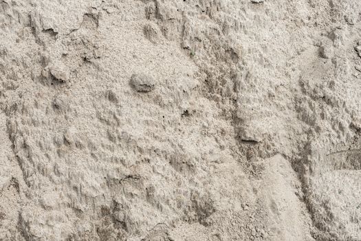 Crust on the dried sand after a downpour . Dried sand