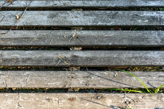 Shield made of wooden boards. Old wooden boards have deteriorated under the rain.