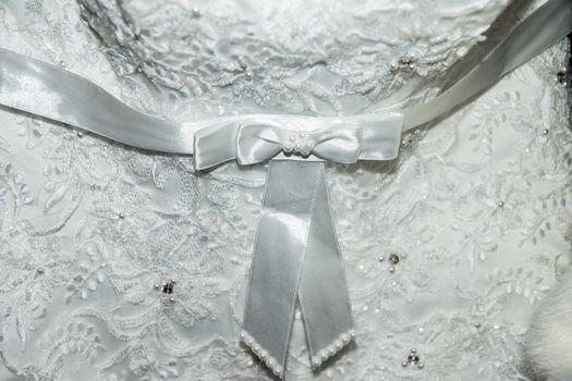 Part of the bride's wedding dress. Bow on the dress. Wedding Dress