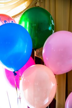 Multicolored balloons. Helium balls. Holiday balls tied to a rope