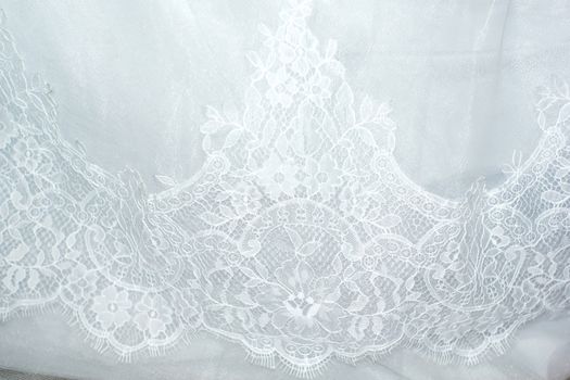 Part of the bride's white dress is decorated with embroidery