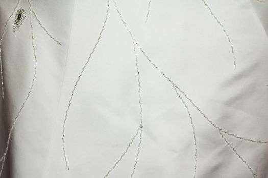 Part of the bride's white dress is decorated with embroidery